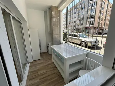 a room with a desk and a large window at Apartamentos Torres del Milladoiro in Amés