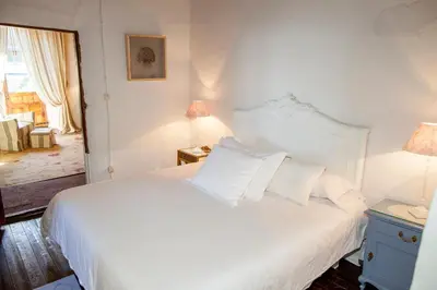 a bedroom with a bed with white sheets and pillows at Arzipreste II Casa del Ama in León