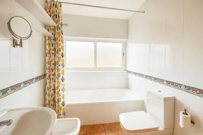 a bathroom with a sink and a toilet and a window at Casa Vixoi, a 5Km Catedral in Santiago de Compostela