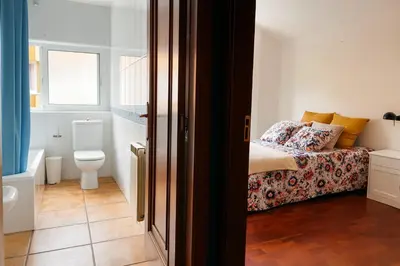 a small bedroom with a bed and a toilet at Casa Vixoi, a 5Km Catedral in Santiago de Compostela