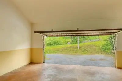 an empty room with an open door to a yard at Casa Vixoi, a 5Km Catedral in Santiago de Compostela