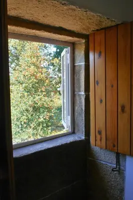 a window in a room with a view of a tree at Casa Ermitas - Relájate en plena naturaleza in A Estrada