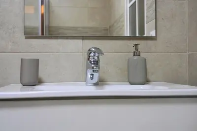 a bathroom sink with a faucet and a soap dispenser at Casa Ermitas - Relájate en plena naturaleza in A Estrada