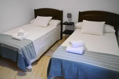 two beds sitting next to each other in a room at Casa Ermitas - Relájate en plena naturaleza in A Estrada
