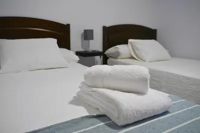 two beds with white towels on top of them at Casa Ermitas - Relájate en plena naturaleza in A Estrada