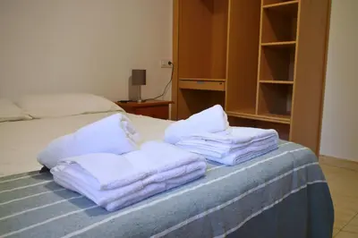 a pile of towels sitting on top of a bed at Casa Ermitas - Relájate en plena naturaleza in A Estrada