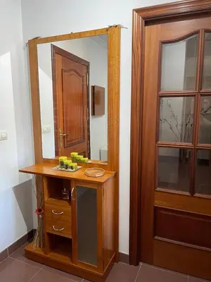 a bathroom with a wooden vanity and a mirror at O piso de Cris in Caldas de Reis