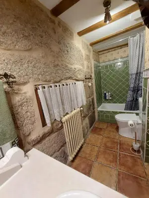 a bathroom with a sink and a toilet and a tub at O Recuncho da Isa - Ribeira Sacra in Pereiro de Aguiar