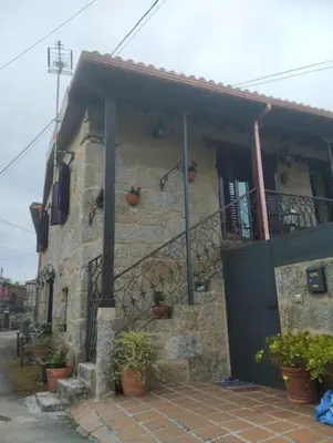 a stone house with potted plants in front of it at O Recuncho da Isa - Ribeira Sacra in Pereiro de Aguiar