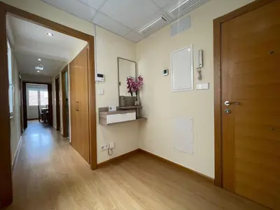 a hallway of an office with a door and flowers on the wall at YourHouse Maca I in Ourense