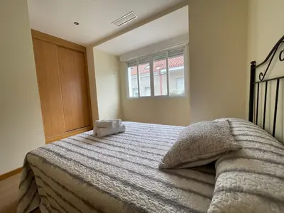a bedroom with a bed and a window at YourHouse Maca I in Ourense