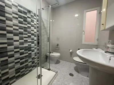a bathroom with a toilet and a sink at YourHouse Maca I in Ourense