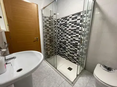 a bathroom with a shower and a sink and a toilet at YourHouse Maca I in Ourense