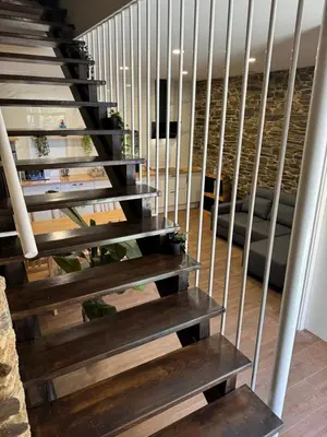 a staircase with wooden steps leading up to a house at Boutique Vila de Triacastela in Tríacastela
