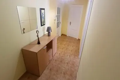 a room with a dresser with a mirror and a hallway at Apartamento céntrico in Foz
