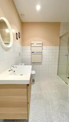 a bathroom with a sink and a toilet and a mirror at The Cliffs A Ribeira - Polas in Foz