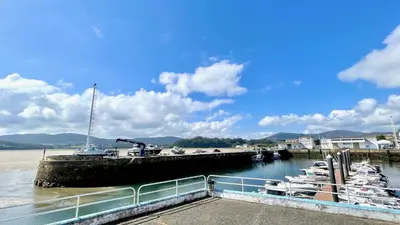 a bunch of boats docked at a dock at The Cliffs A Ribeira - Polas in Foz