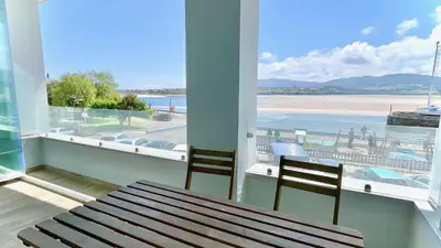 a balcony with a bench and a view of a beach at The Cliffs A Ribeira - Llas in Foz