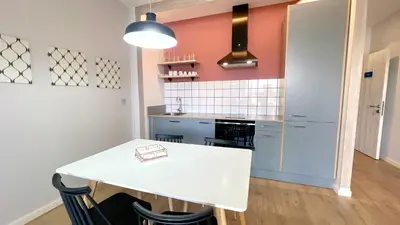 a kitchen with a white table and some chairs at The Cliffs A Ribeira - Llas in Foz