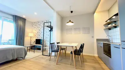a bedroom with a bed and a table and chairs at The Cliffs A Ribeira - Llas in Foz