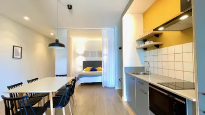 a kitchen and dining room with a table and chairs at The Cliffs A Ribeira - Areoura in Foz