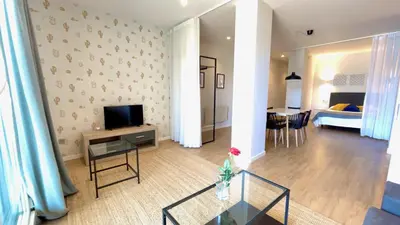 a living room with a television and a dining room at The Cliffs A Ribeira - Areoura in Foz