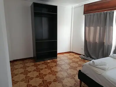 a bedroom with a bed with blue pillows at A Ribeira in Fene
