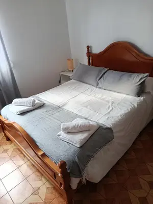 a bedroom with two beds and a window at A Ribeira in Fene