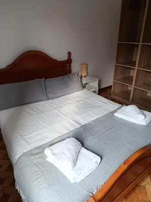 a bedroom with two beds and a window at A Ribeira in Fene