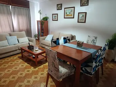 a kitchen with white cabinets and a sink and a refrigerator at A Ribeira in Fene