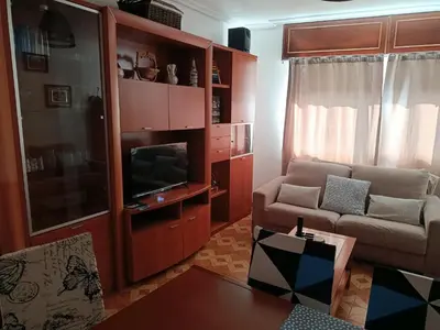 a living room with a couch and a television at A Ribeira in Fene