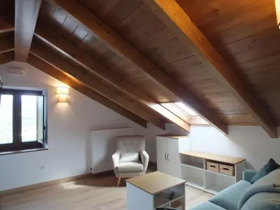a living room with a couch and a chair at Apartamentos Rurales Torre de la Alcandra - 3 llaves - Asturias in Vegadeo