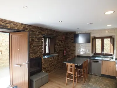 a kitchen with a table and a counter top at Apartamentos Rurales Torre de la Alcandra - 3 llaves - Asturias in Vegadeo