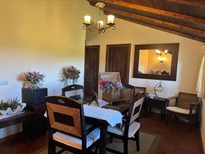 a dining room with a table and chairs and a mirror at Casa Labrega da Torre in Silleda