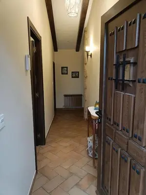 a hallway with a large wooden door in a room at Casa Labrega da Torre in Silleda