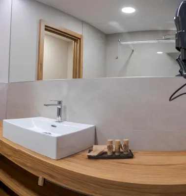 a bathroom with a white sink and a mirror at La Finca in Lugo