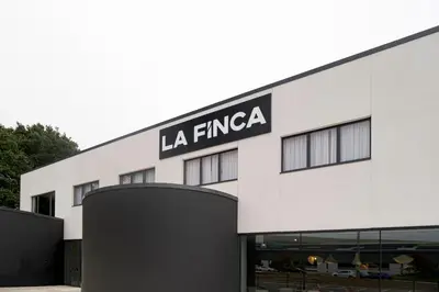a building with the sign for la firma at La Finca in Lugo