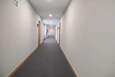 a corridor of an office building with a long hallway at La Finca in Lugo