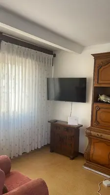 a living room with a large flat screen tv at As pontes apartamento in Puentes de García Rodríguez