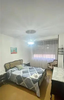 a bedroom with a bed and a window at As pontes apartamento in Puentes de García Rodríguez