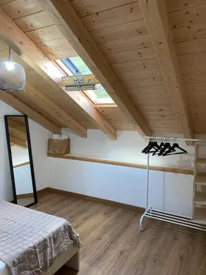 a bedroom with a bed and a wooden ceiling at A Chupiña in Balboa