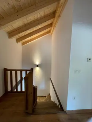 a staircase in a building with wooden beams at A Chupiña in Balboa