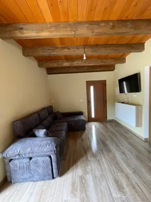 a living room with a couch and a tv at A Chupiña in Balboa
