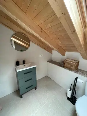 a bathroom with a sink and a mirror at A Chupiña in Balboa