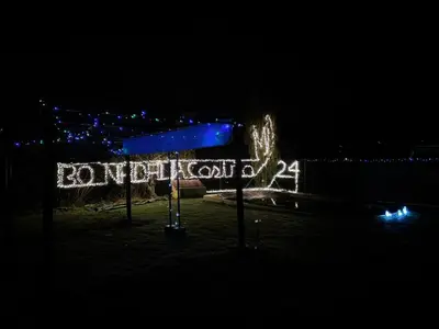 a sign that is lit up at night at Welcome A Casiña de Arcos de Furcos in Cuntis