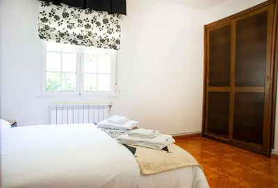 a bedroom with a white bed and a window at Welcome A Casiña de Arcos de Furcos in Cuntis