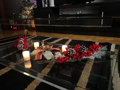 a glass table with candles and christmas decorations on it at Welcome A Casiña de Arcos de Furcos in Cuntis