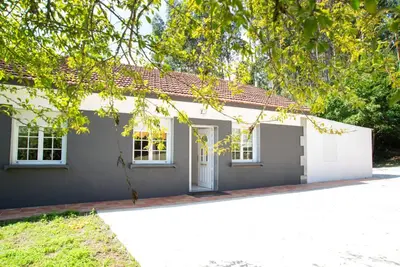 a small white house with a white garage at Welcome A Casiña de Arcos de Furcos in Cuntis