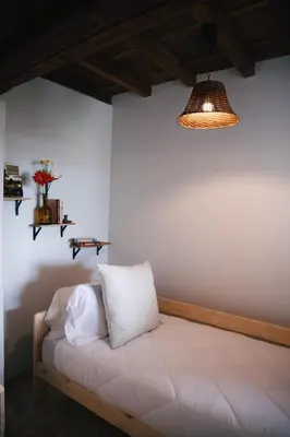 a room with a bed with a pillow on it at Casa Trillo en centro de Monforte de Lemos in Monforte de Lemos