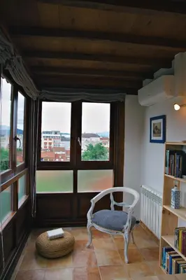 a room with a chair and a large window at Casa Trillo en centro de Monforte de Lemos in Monforte de Lemos